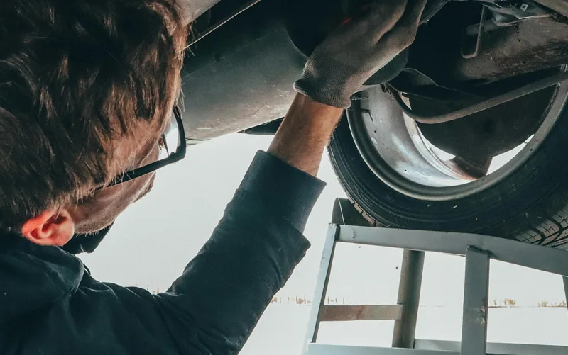 guy working on golf cart - golf cart maintenance in Colorado